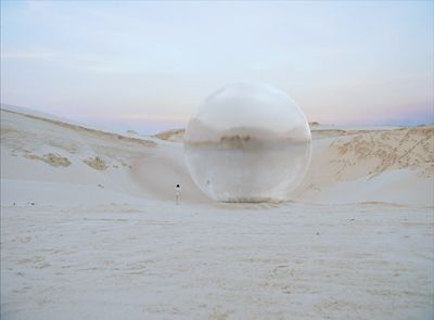 a large bubble sitting in the middle of a desert