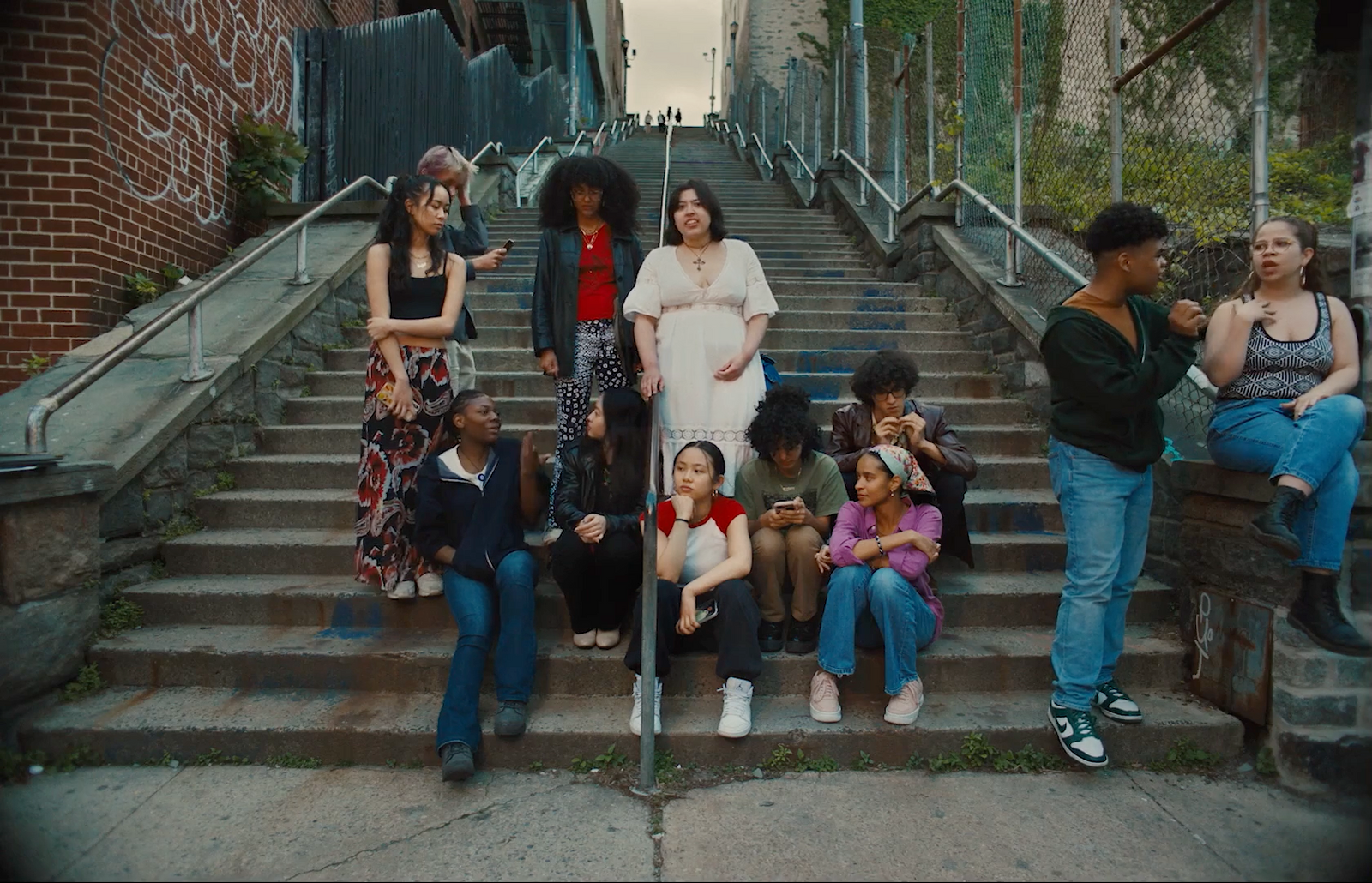 a group of people sitting on the steps of a building