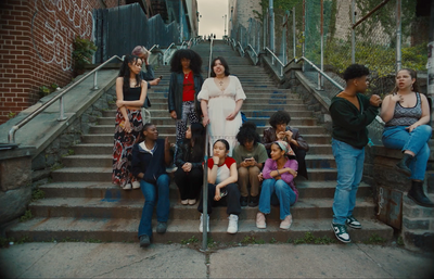 a group of people sitting on the steps of a building