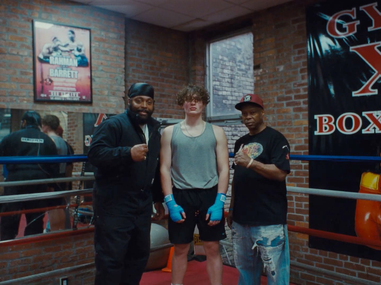 a group of men standing next to each other in a boxing ring