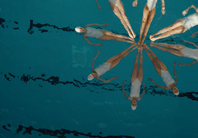 a group of people floating on top of a body of water