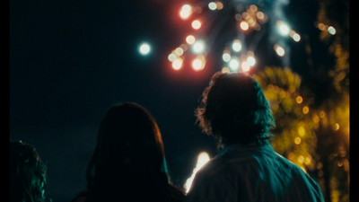 a group of people watching fireworks in the sky