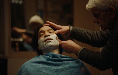 a man getting a facial mask on his face