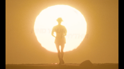 a person standing in front of a large sun