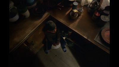 a man standing in a kitchen next to a counter