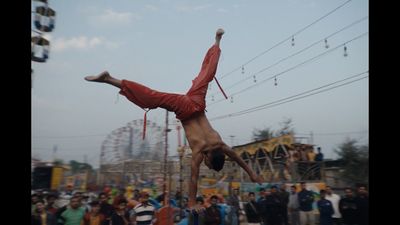 a man doing a handstand in front of a crowd