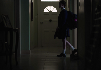 a person in a dark hallway with a backpack