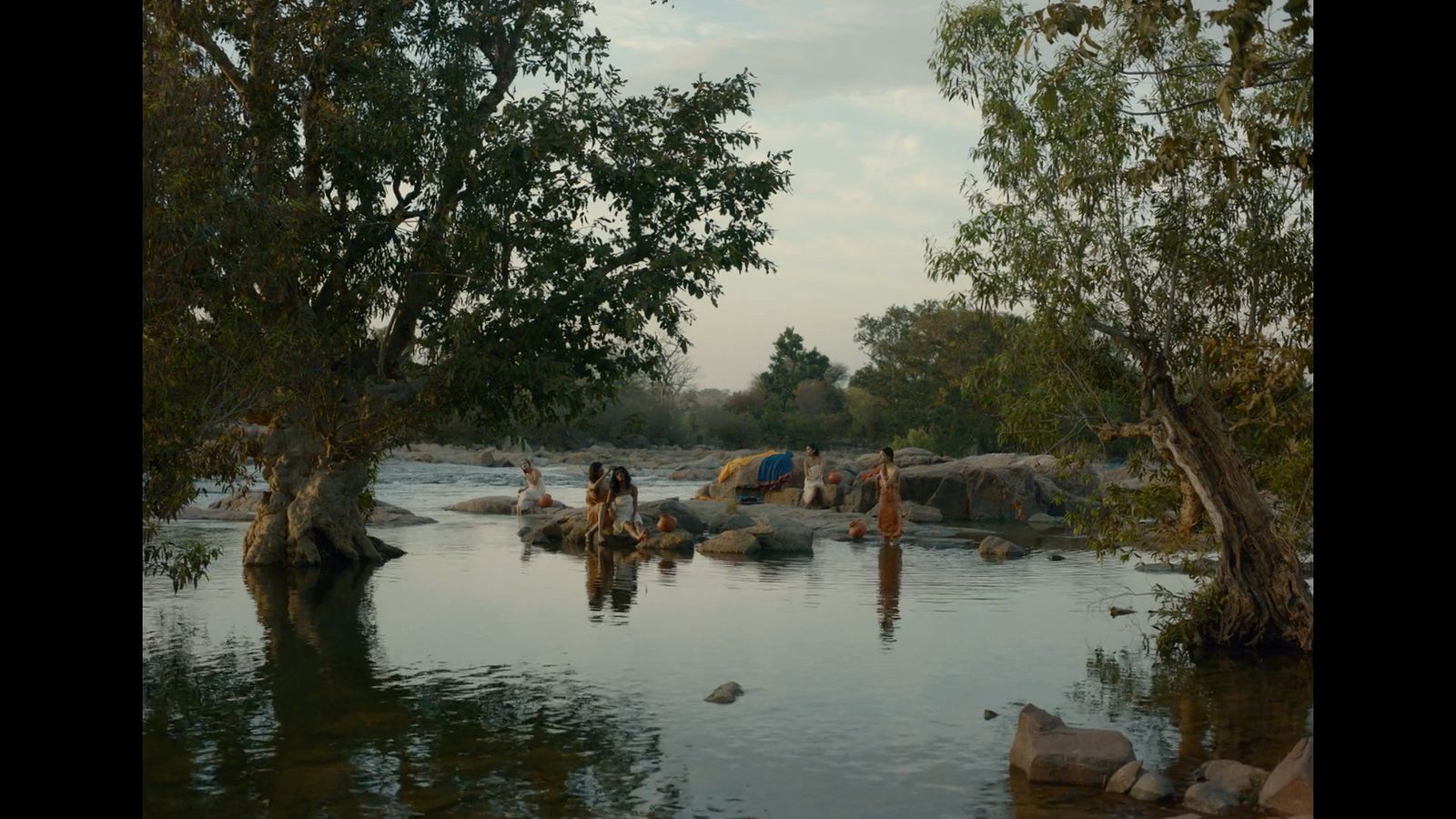 a group of people are standing in the water