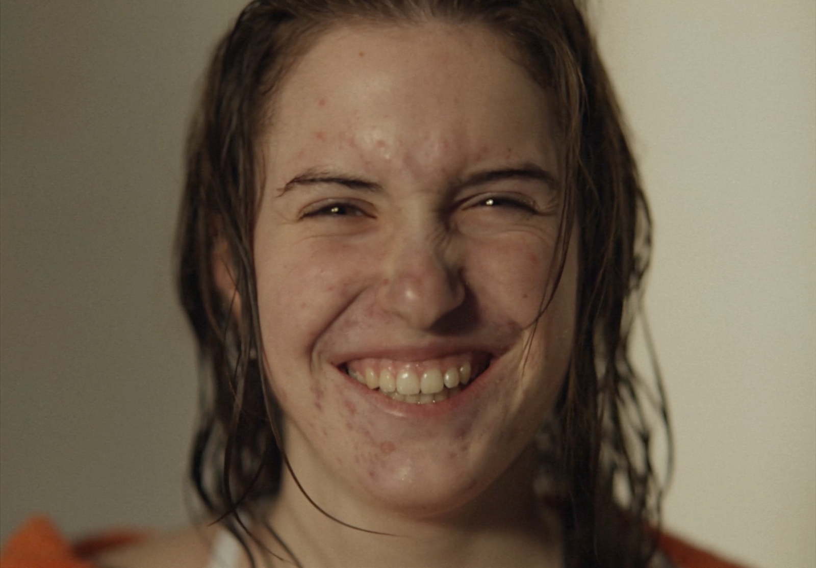 a woman with freckled hair smiling for the camera