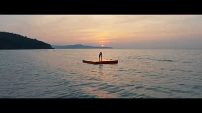 a person standing on a boat in the middle of the ocean