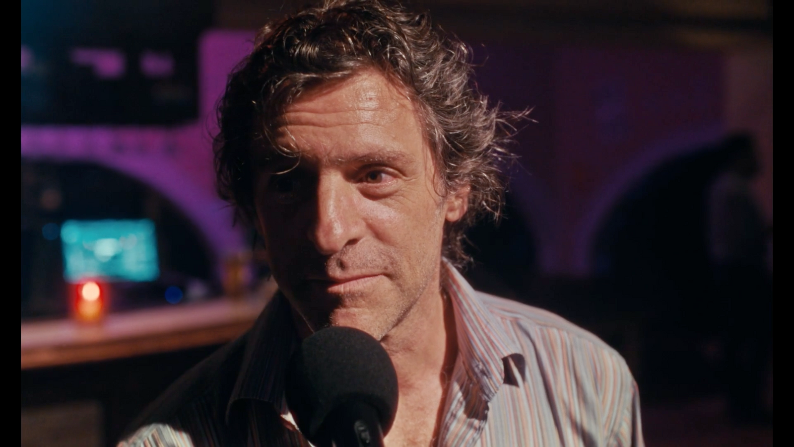 a man holding a microphone in front of a microphone