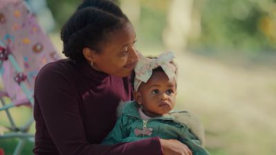 a woman holding a small child in her arms