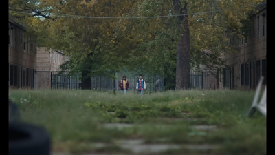 a couple of people standing in the grass