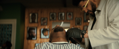 a man getting his hair cut by a barber