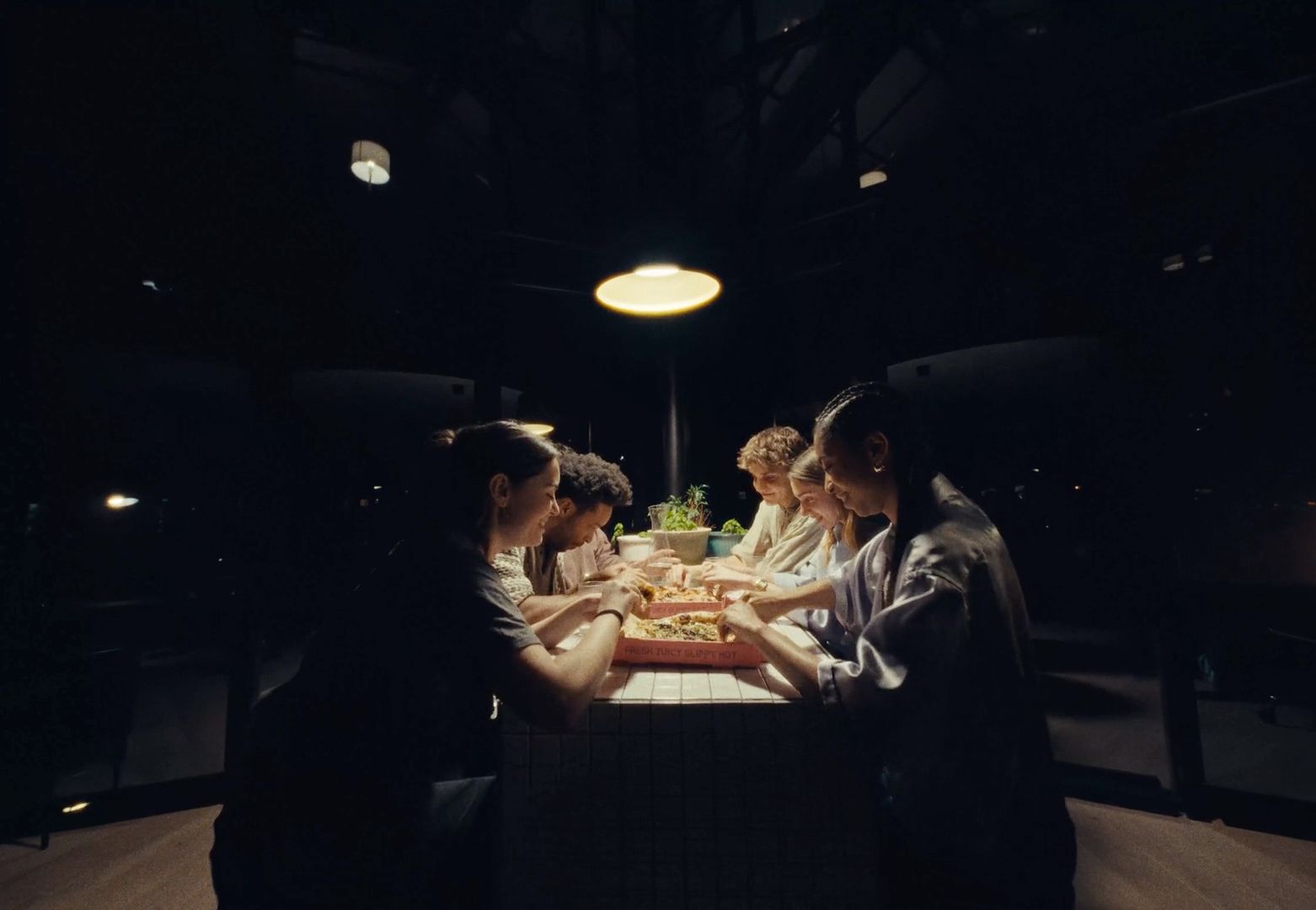 a group of people sitting around a table eating food