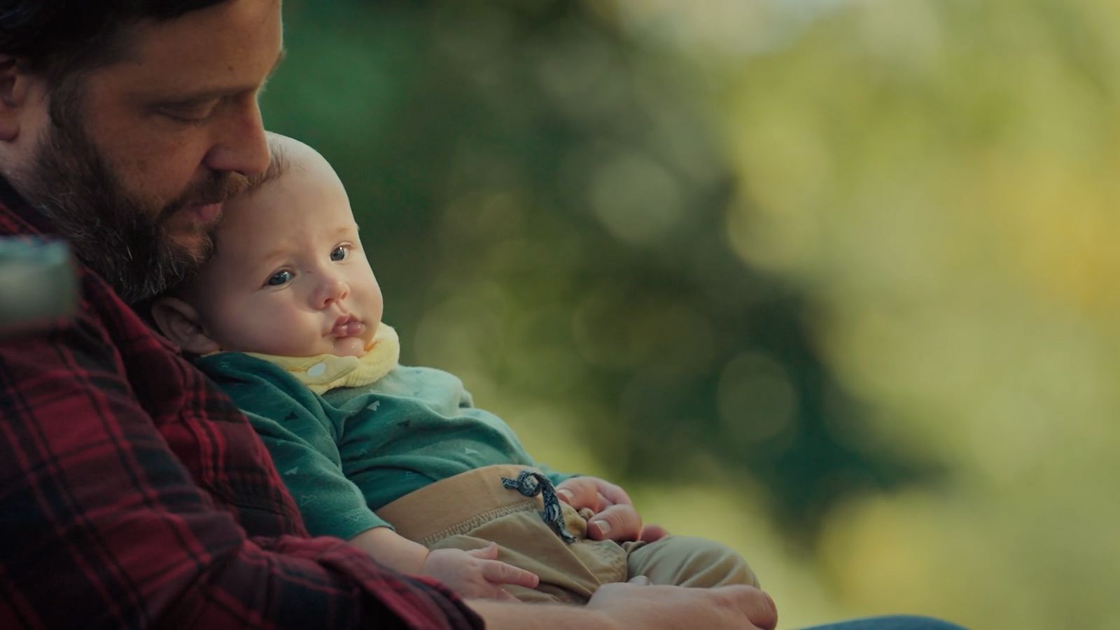 a man holding a baby in his arms