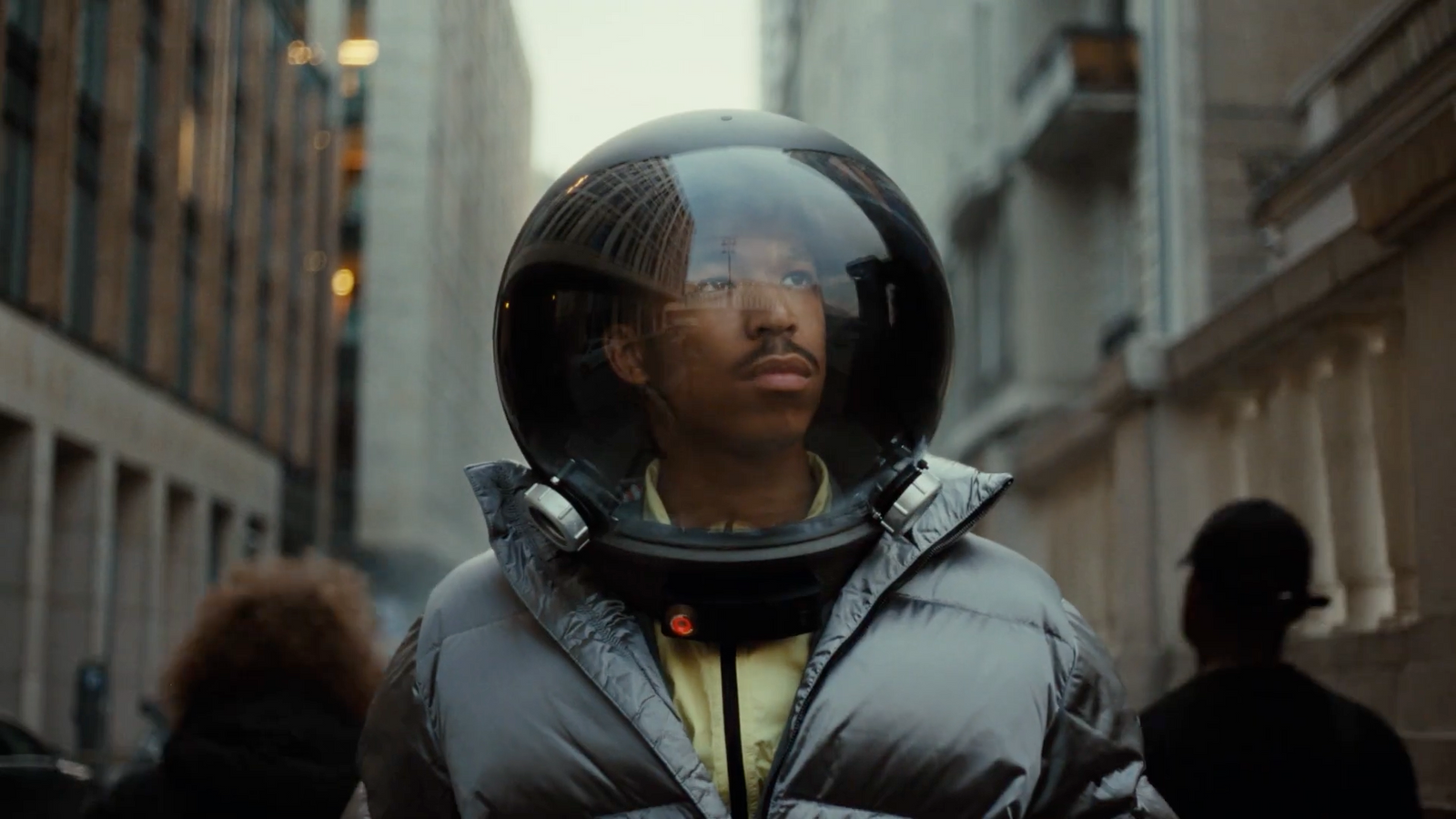 a man in a space suit standing in the middle of a street