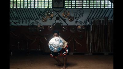 a man holding a soccer ball in his hands