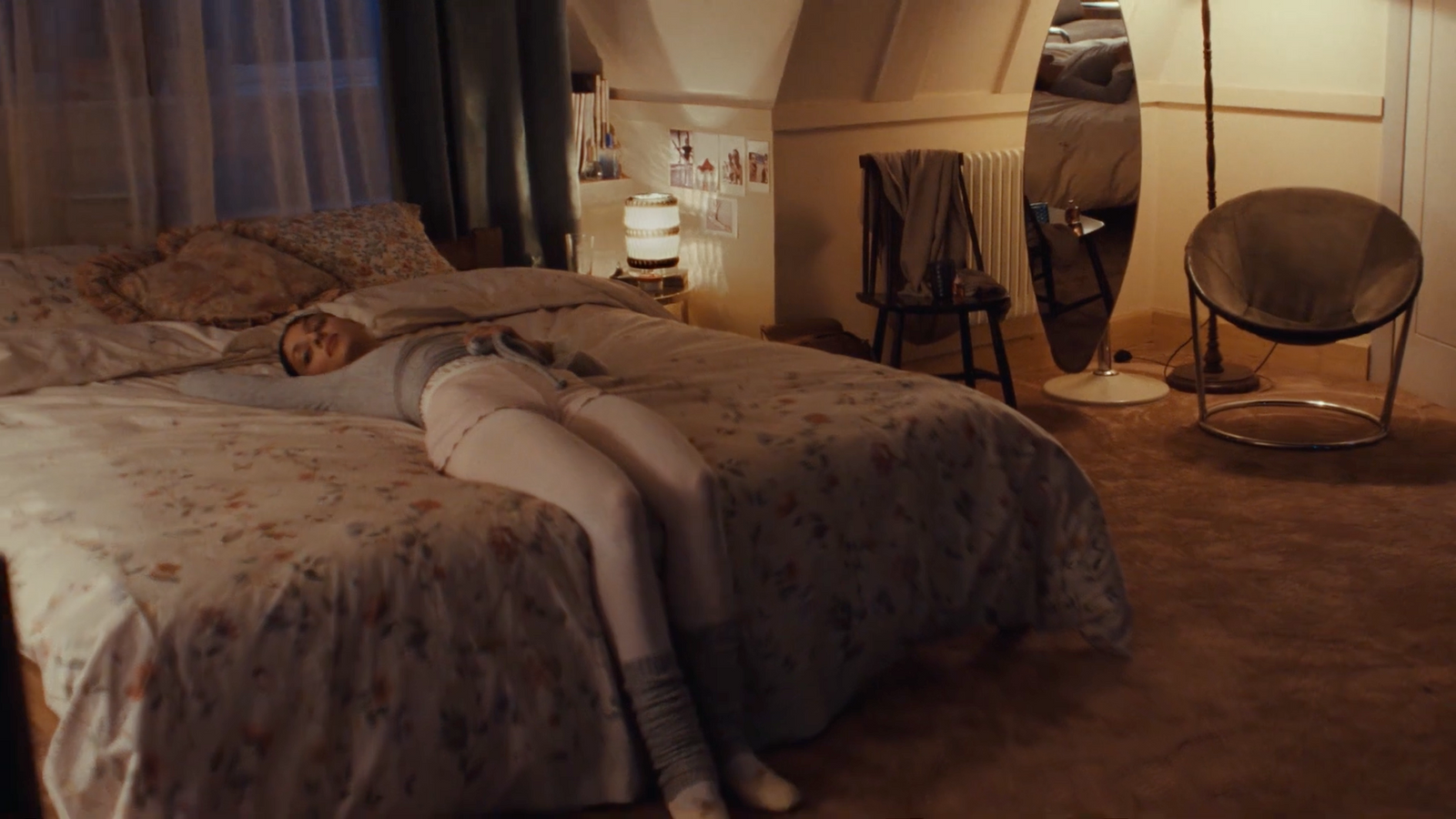 a woman laying on a bed in a bedroom