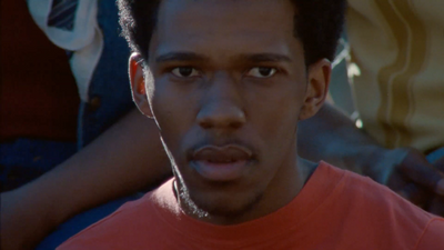 a close up of a person wearing a red shirt