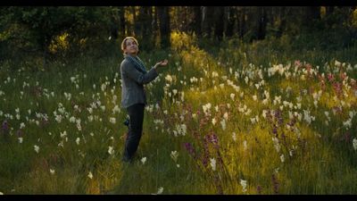 a woman standing in a field of flowers