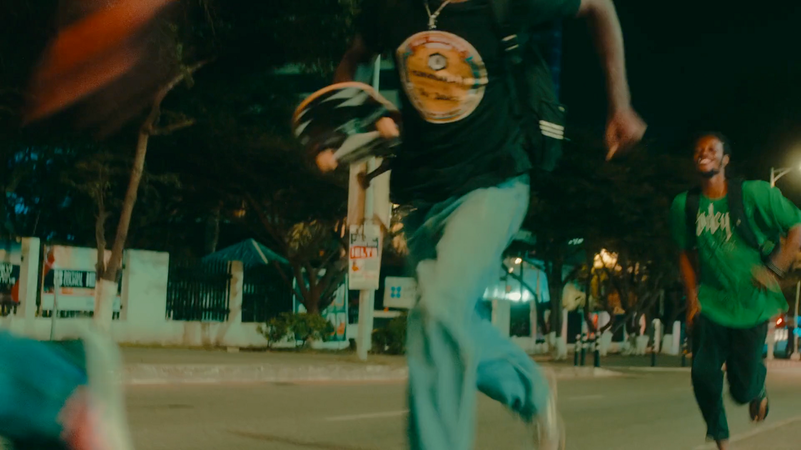 a group of young men riding skateboards down a street