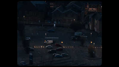 a parking lot filled with lots of parked cars