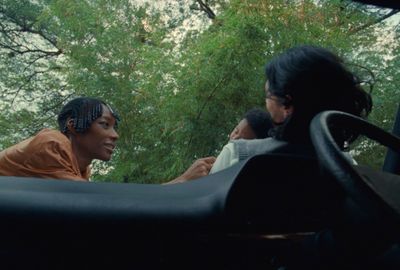 a group of people sitting in the back of a truck