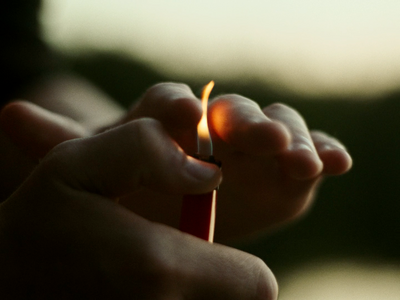 a person holding a lighter in their hands