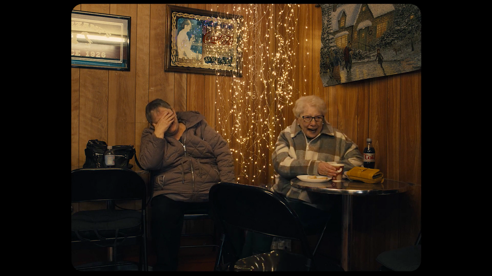 two people sitting at a table eating food