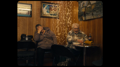 two people sitting at a table eating food