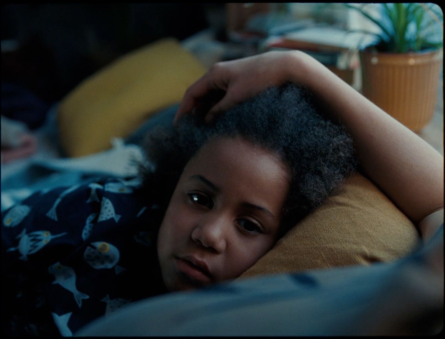 a woman laying in bed with her head on a pillow