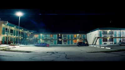 an empty parking lot in front of a motel