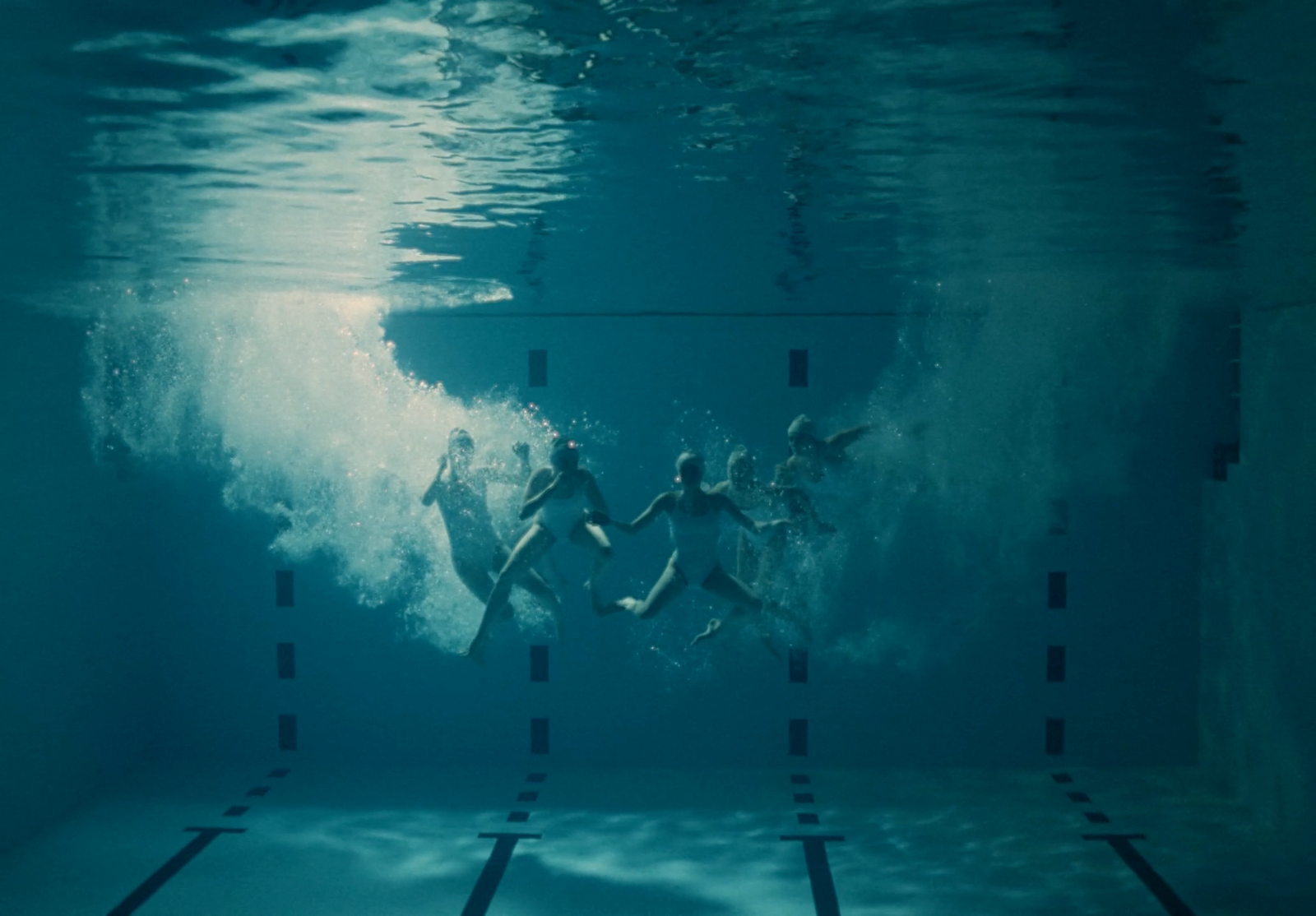 a group of people swimming in a pool