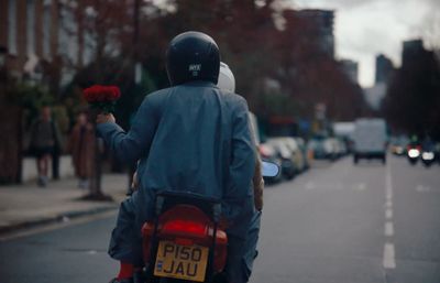 a person riding a motorcycle down a street