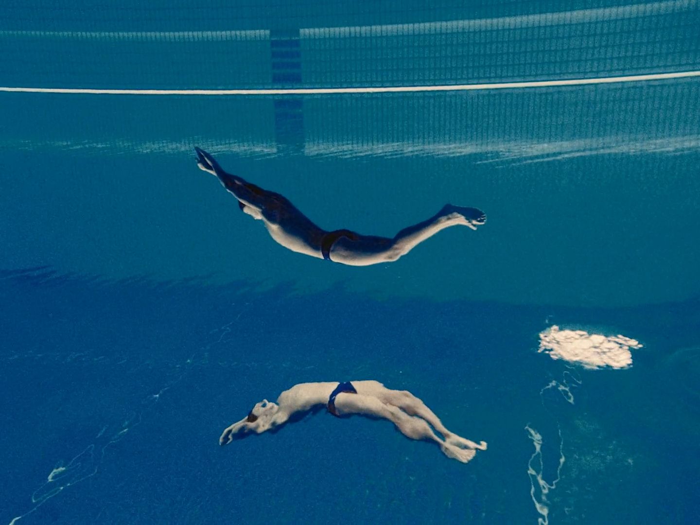 a person swimming in a pool with a net