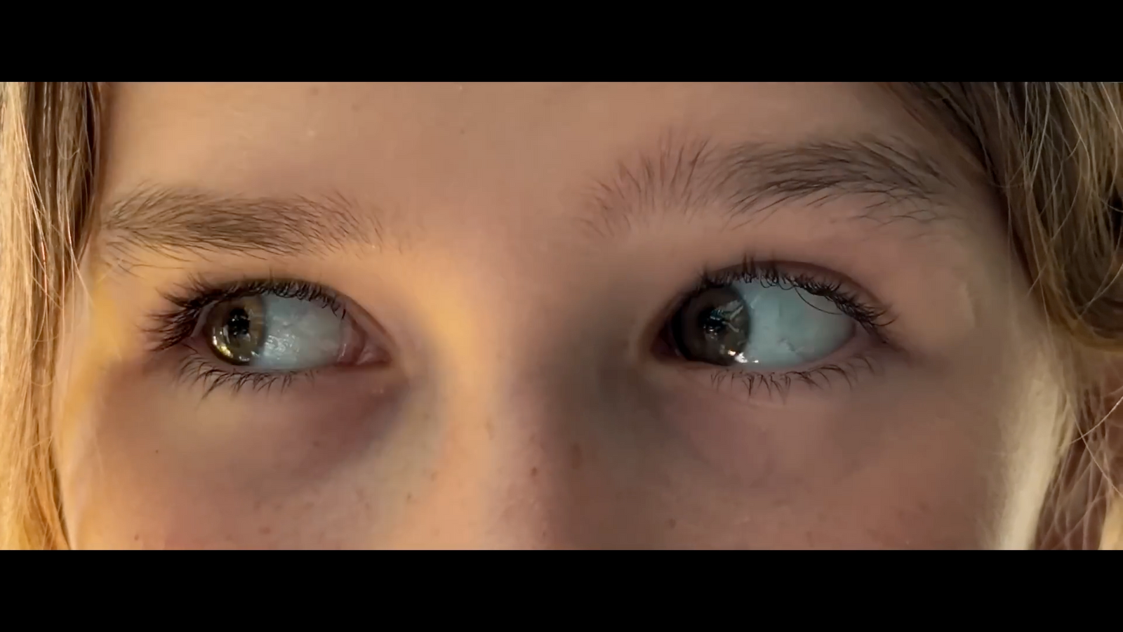 a close up of a child's blue eyes