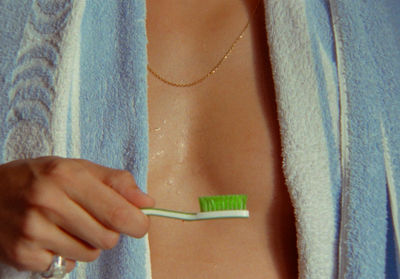 a close up of a person holding a toothbrush