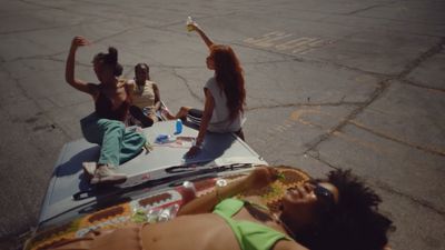 a group of people sitting on top of a car