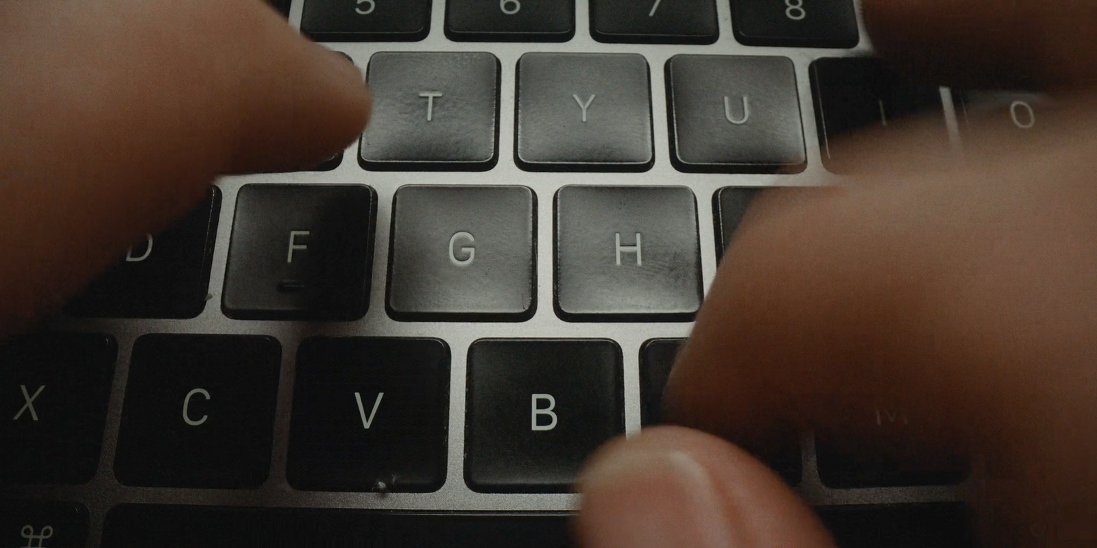 a close up of a person typing on a keyboard