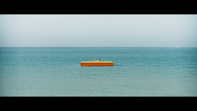 a yellow boat floating on top of a large body of water