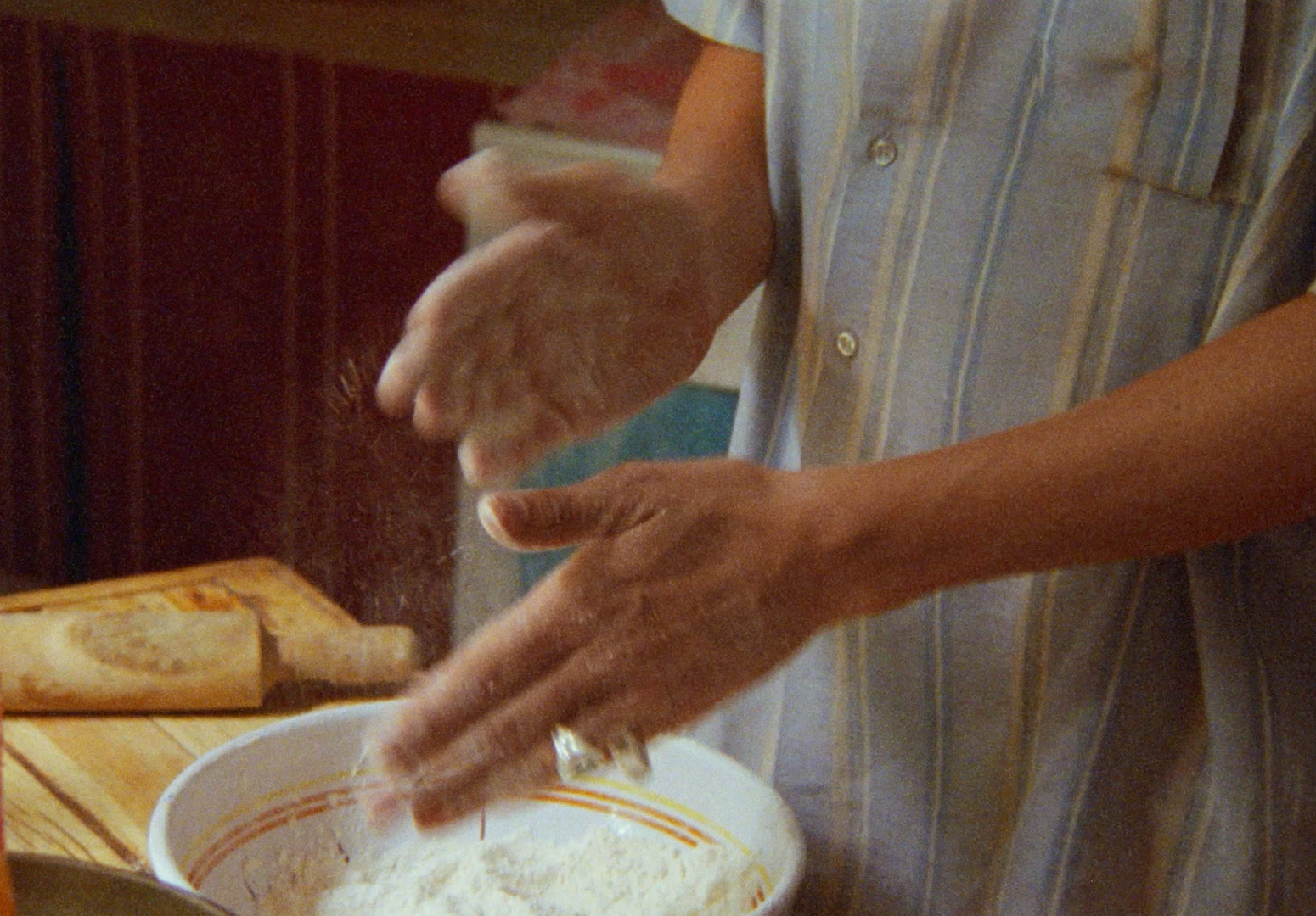 a man is mixing something in a bowl