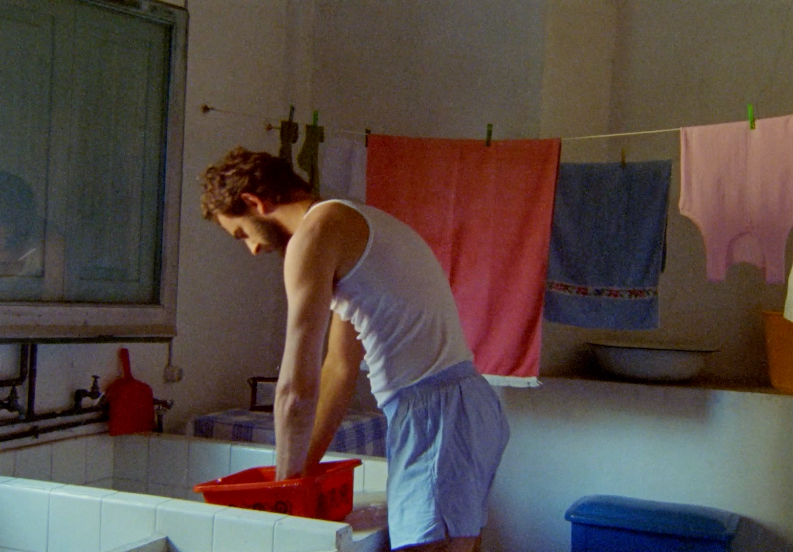 a man is washing his hands in the sink