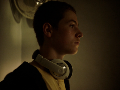 a young man wearing headphones in a dark room