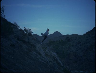 a person standing on top of a rocky hill