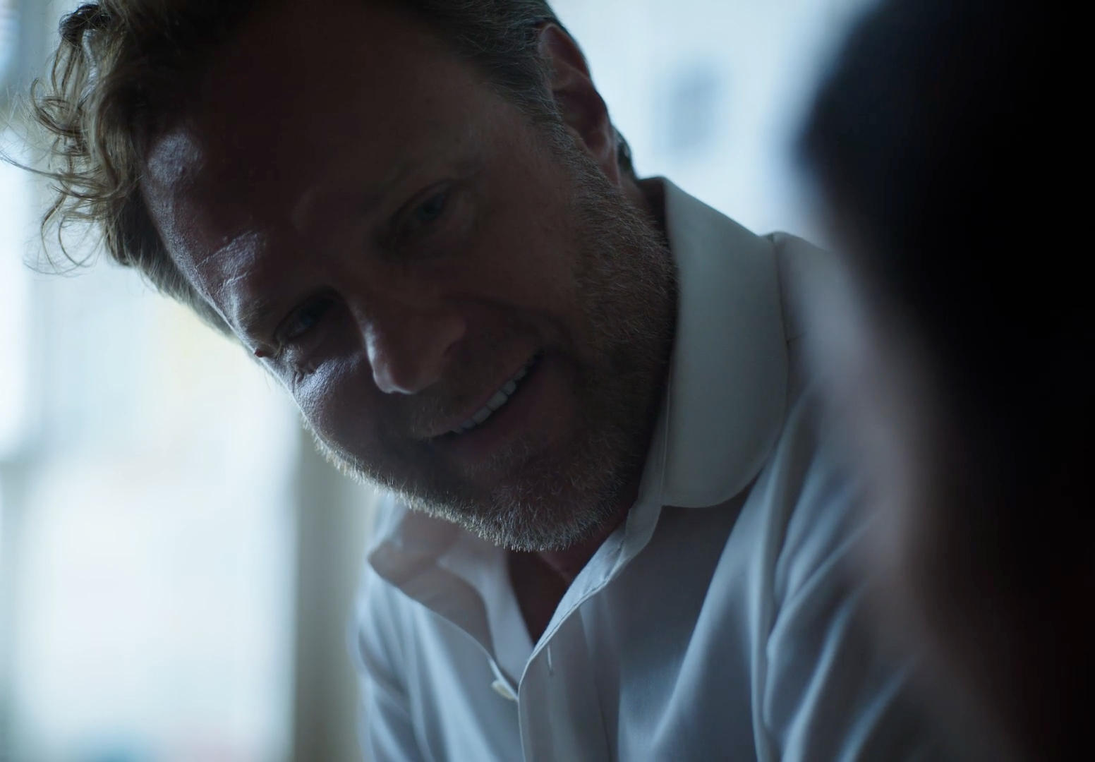 a close up of a person wearing a white shirt