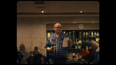 a man standing in a room holding a piece of paper