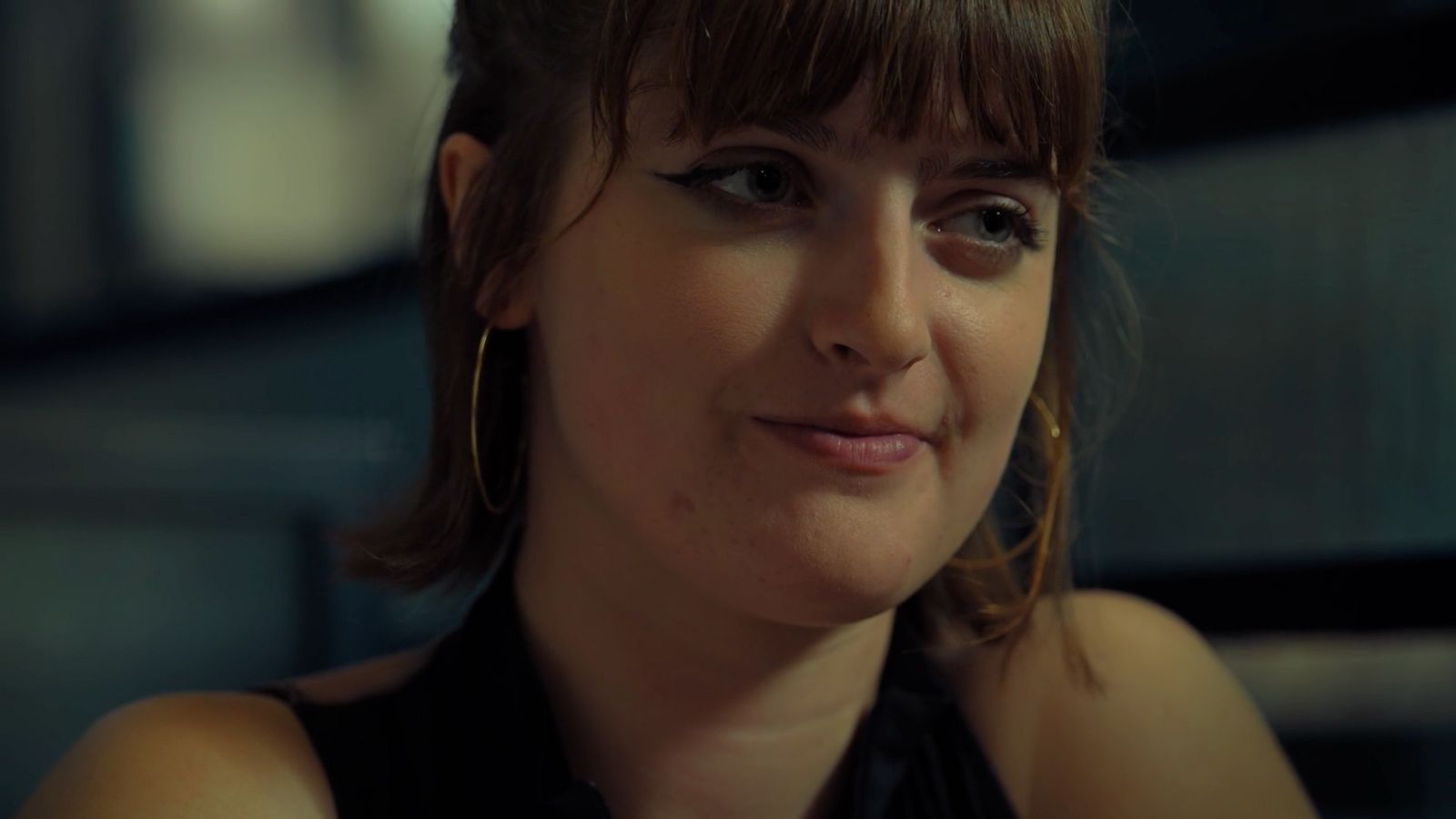 a close up of a person wearing a black shirt