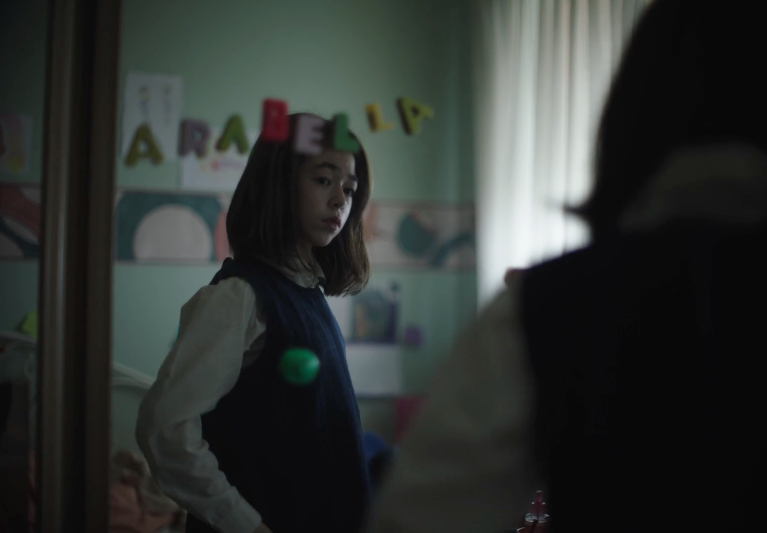 a woman standing in a room with a mirror