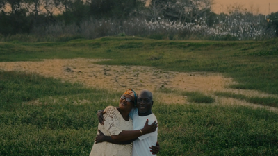 a couple of people that are standing in the grass